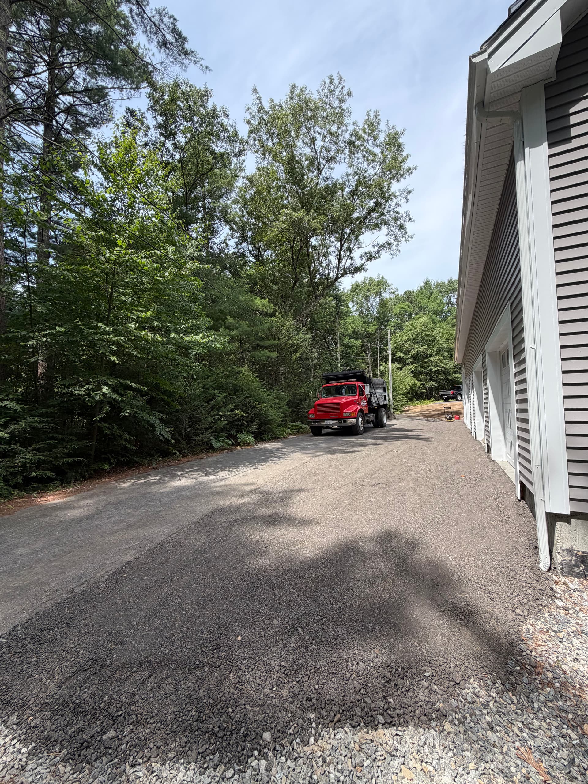 Garage Apron Regrind and Stone Wall Fixes a Drainage Problem