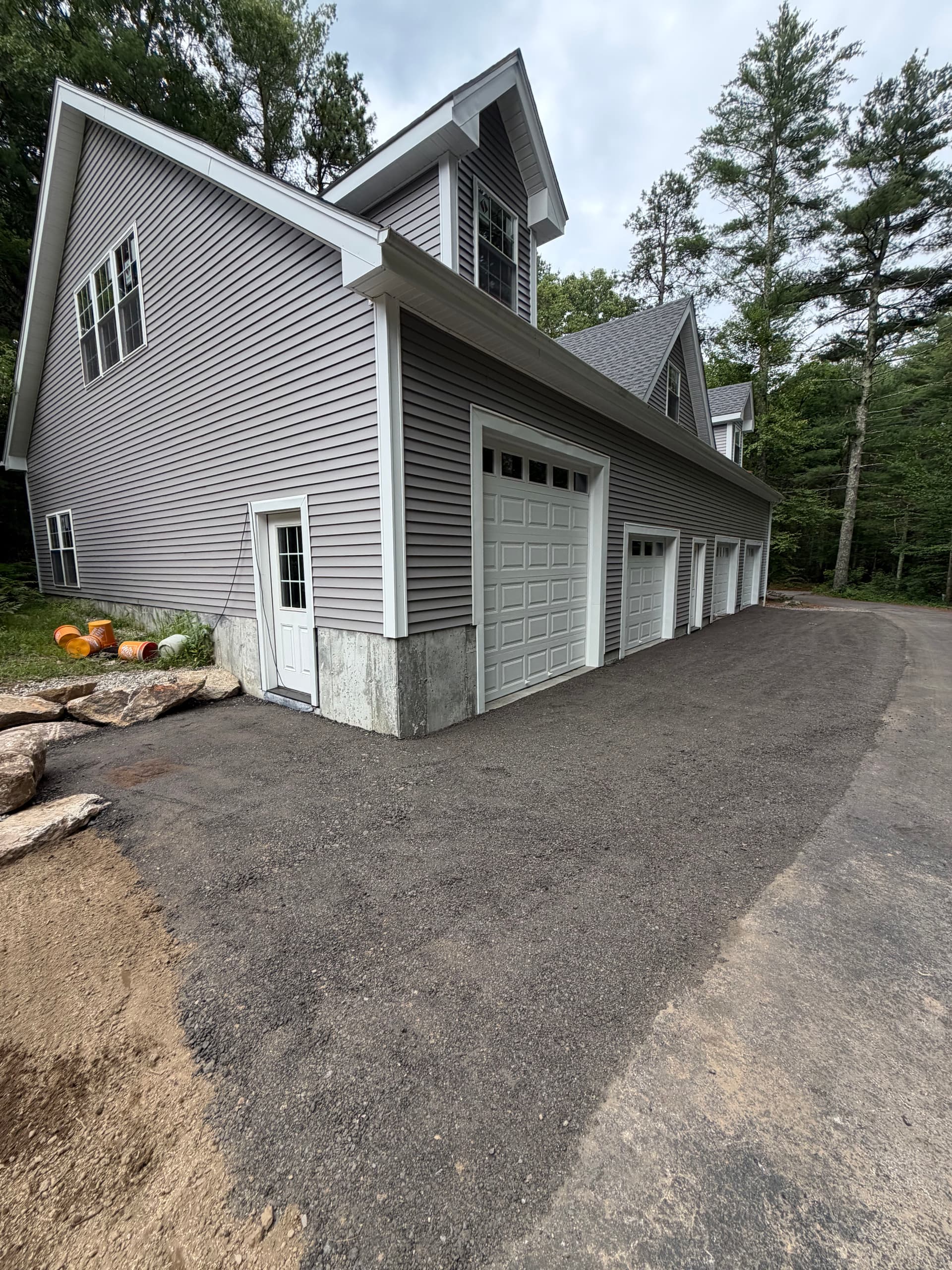 Garage Apron Regrind and Stone Wall Fixes a Drainage Problem